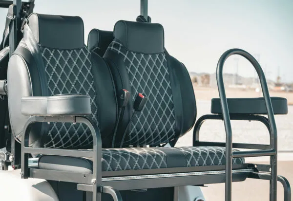 Rear flip seat with diamond-stitched padding and storage rack on EPIC e40L street-legal cart