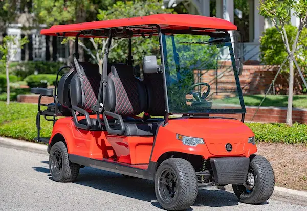 EPIC e60 6-passenger electric golf cart in bright red with diamond-stitched black seating, designed for family and group transport in Sarasota