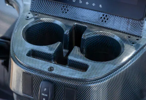Carbon fiber-style dashboard and dual cup holders in ICON i60 electric golf cart